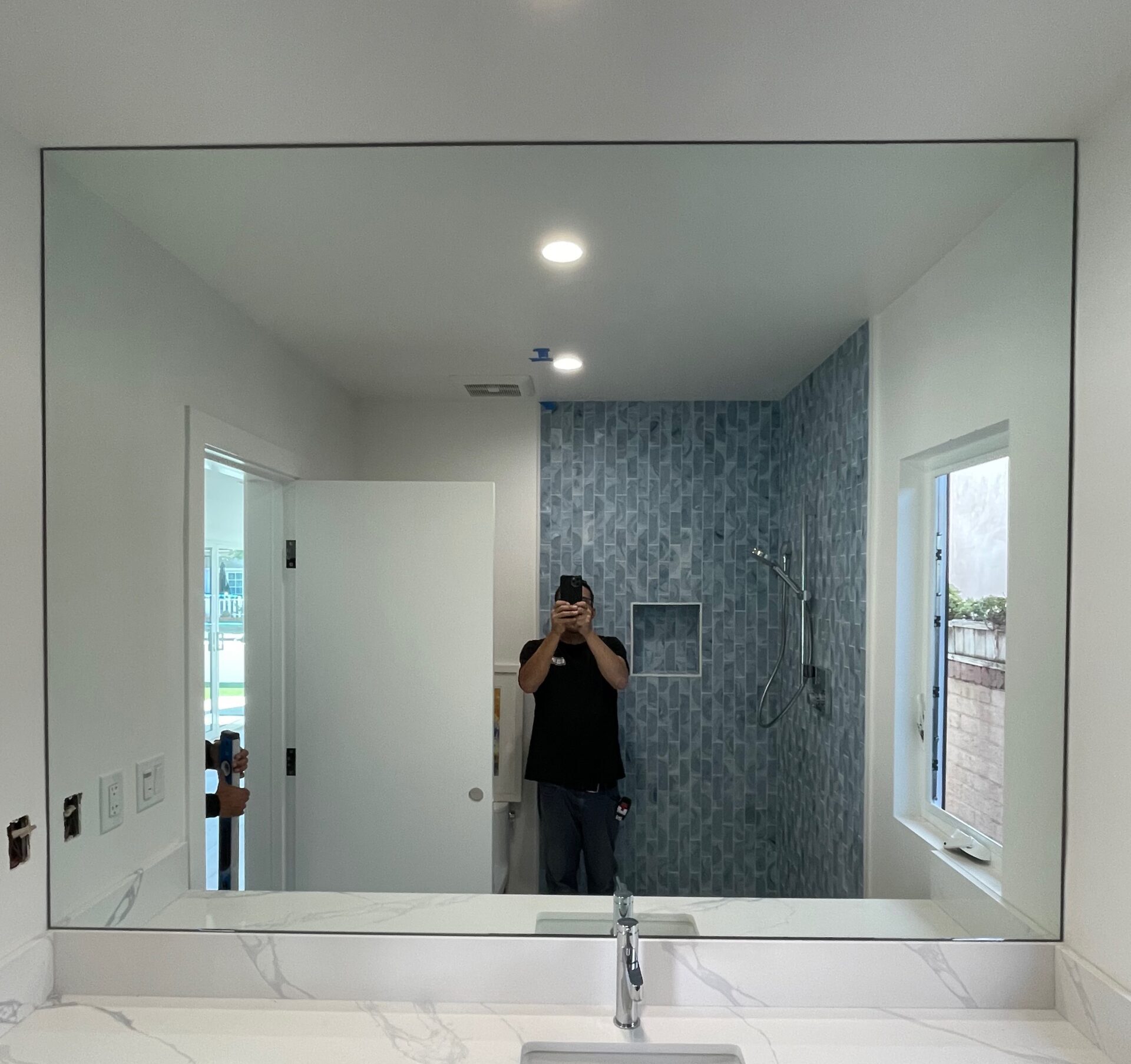 Custom full-width bathroom mirror installed by Champion Glass & Mirror