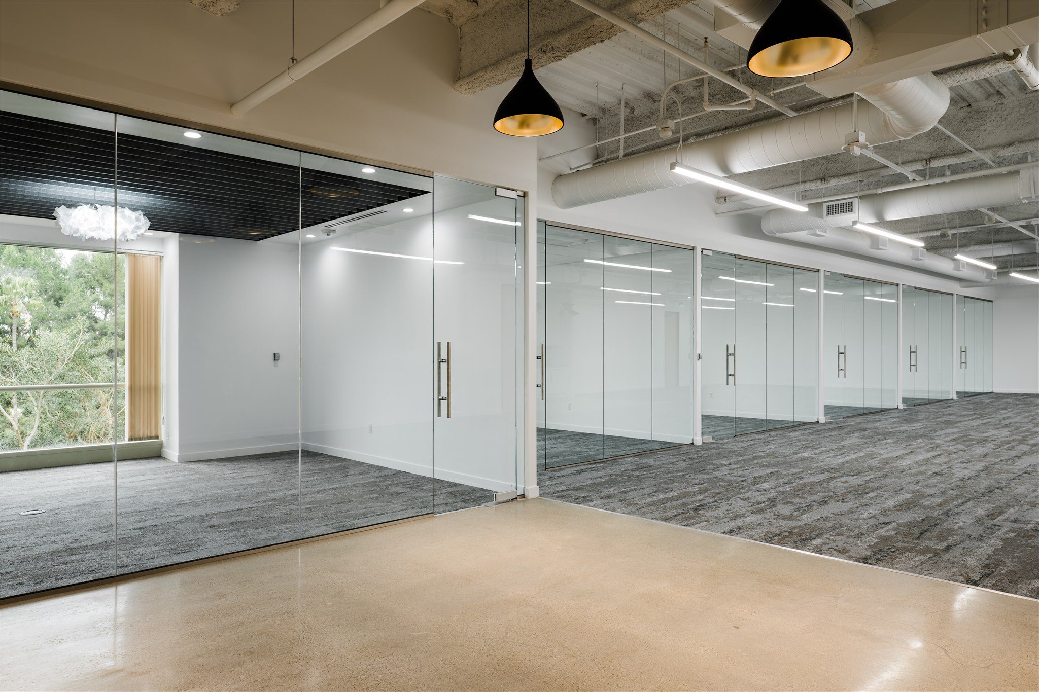 Close-up of glass partition hardware and door handle in Irvine office