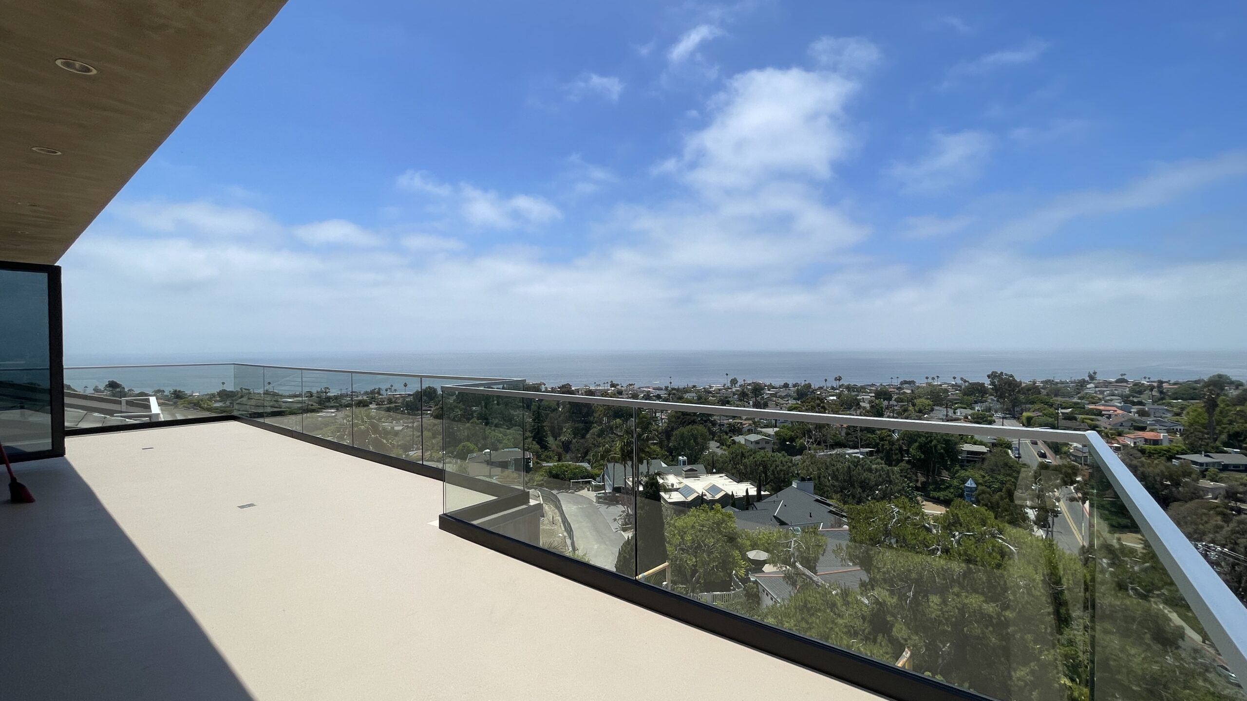 Glass railing installation with top cap in Laguna Beach CA balcony overlooking ocean view